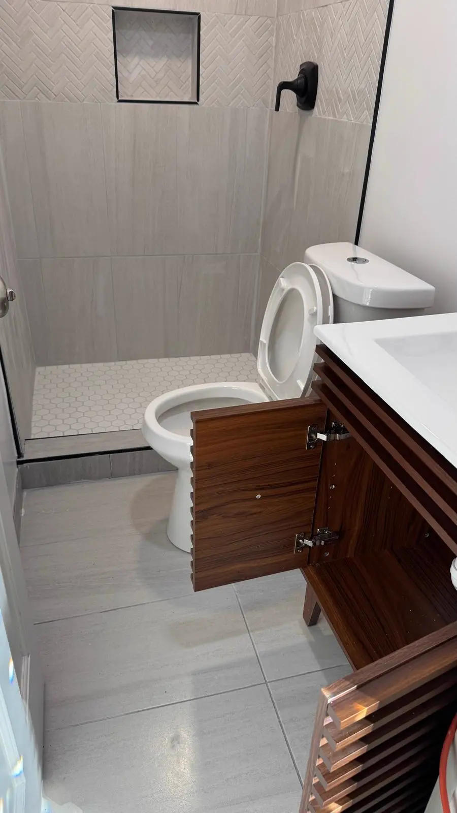 Baño remodelado con ducha a nivel y vanidad instalada